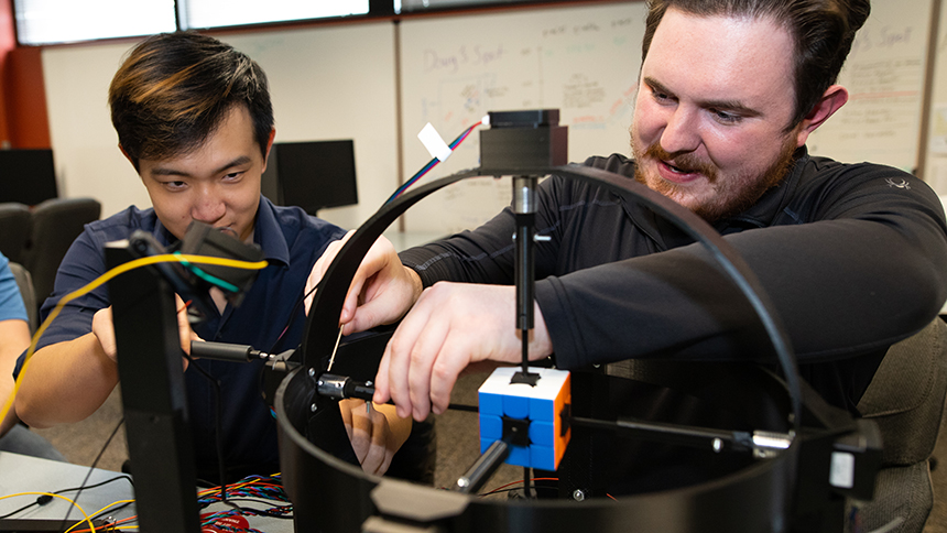 John Duong '22 and Logan Jepson '22 work on their computer science capstone — a Rubik's Club solving robot