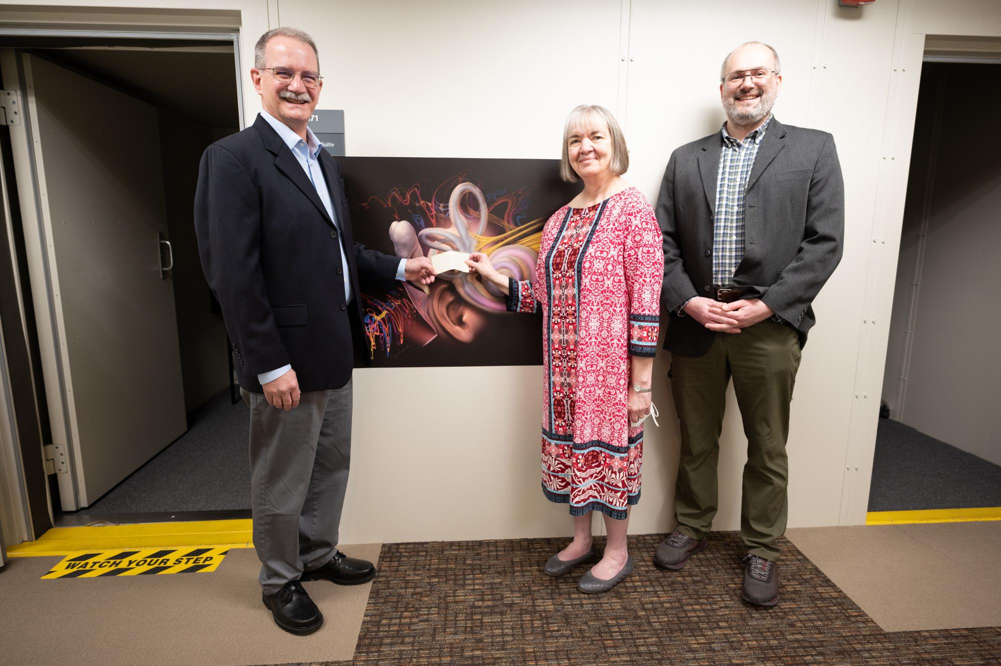 Matt Brink (left) of the Hillsboro Lions Club presents Pacific School of Audiology Director Wendy Hanks (center) and Assistant Professor of Audiology Marcin Wróblewski (right) with a check for the School of Audiology Legacy Scholarship