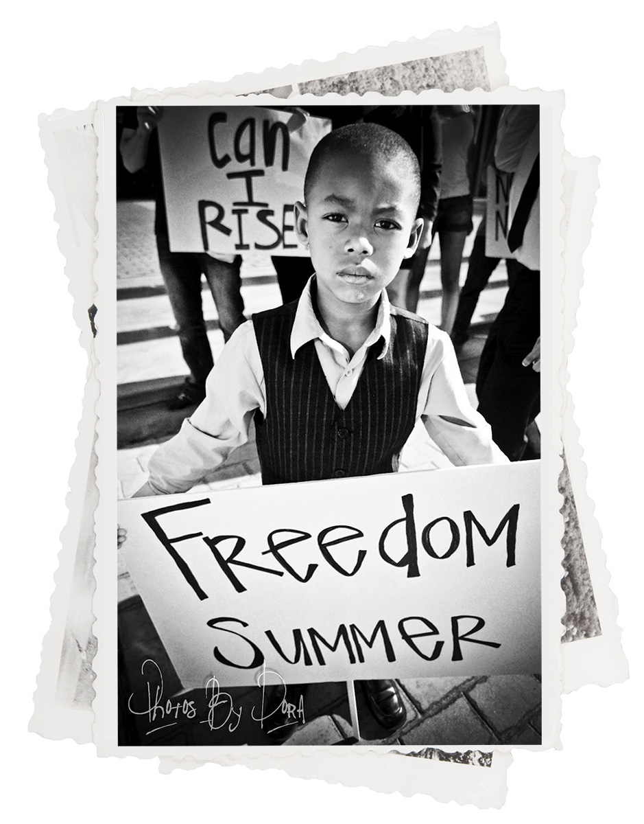 Young boy holding banner up.
