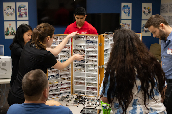 People view a display filled with glasses