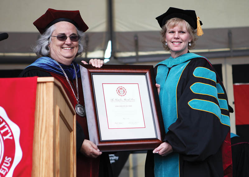 President Lesley Hallick, left, presents Dori Carlson OD '89 with the 2013 Massih Prize.