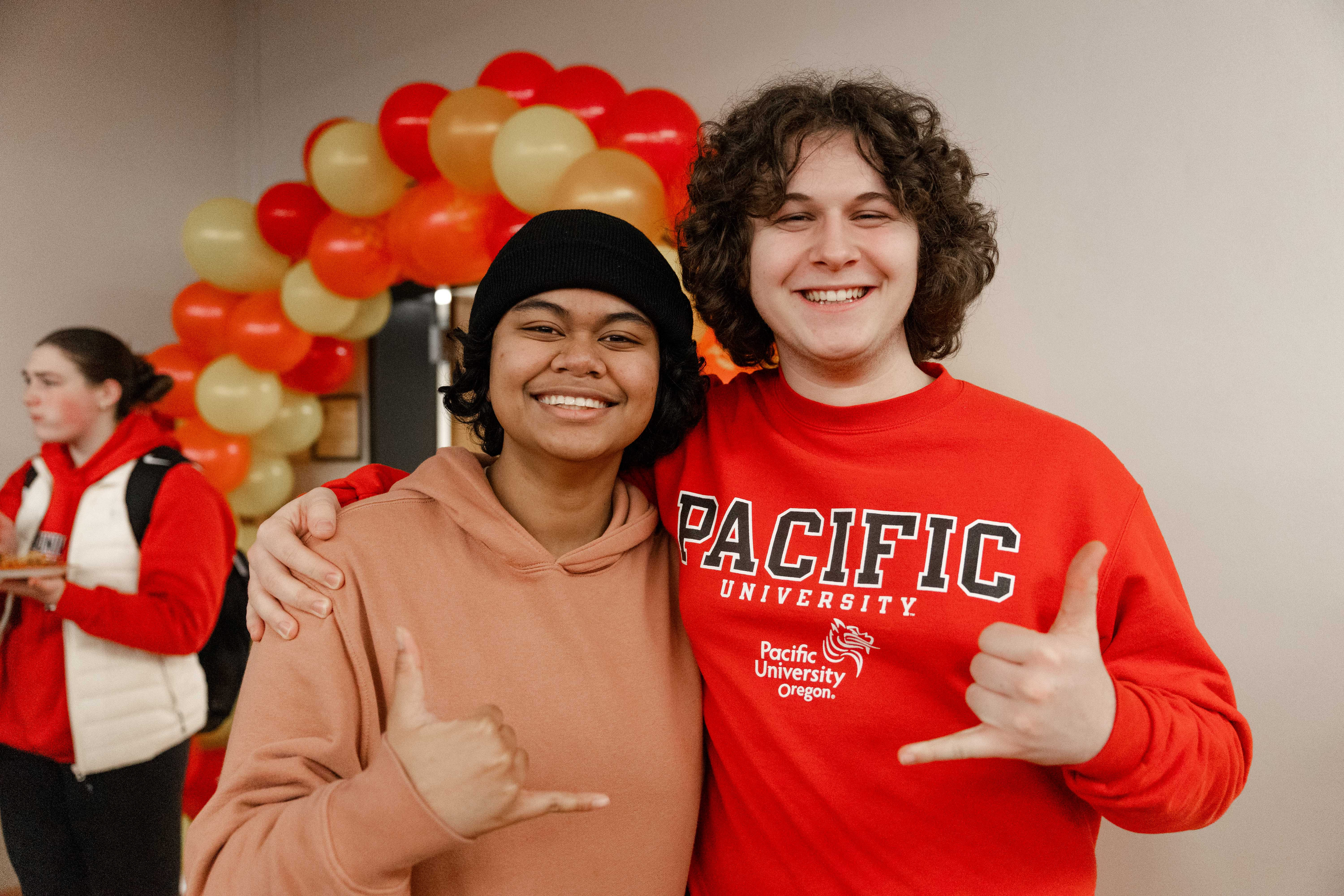 Two students pose for a photo during a Lunar New Year celebration.