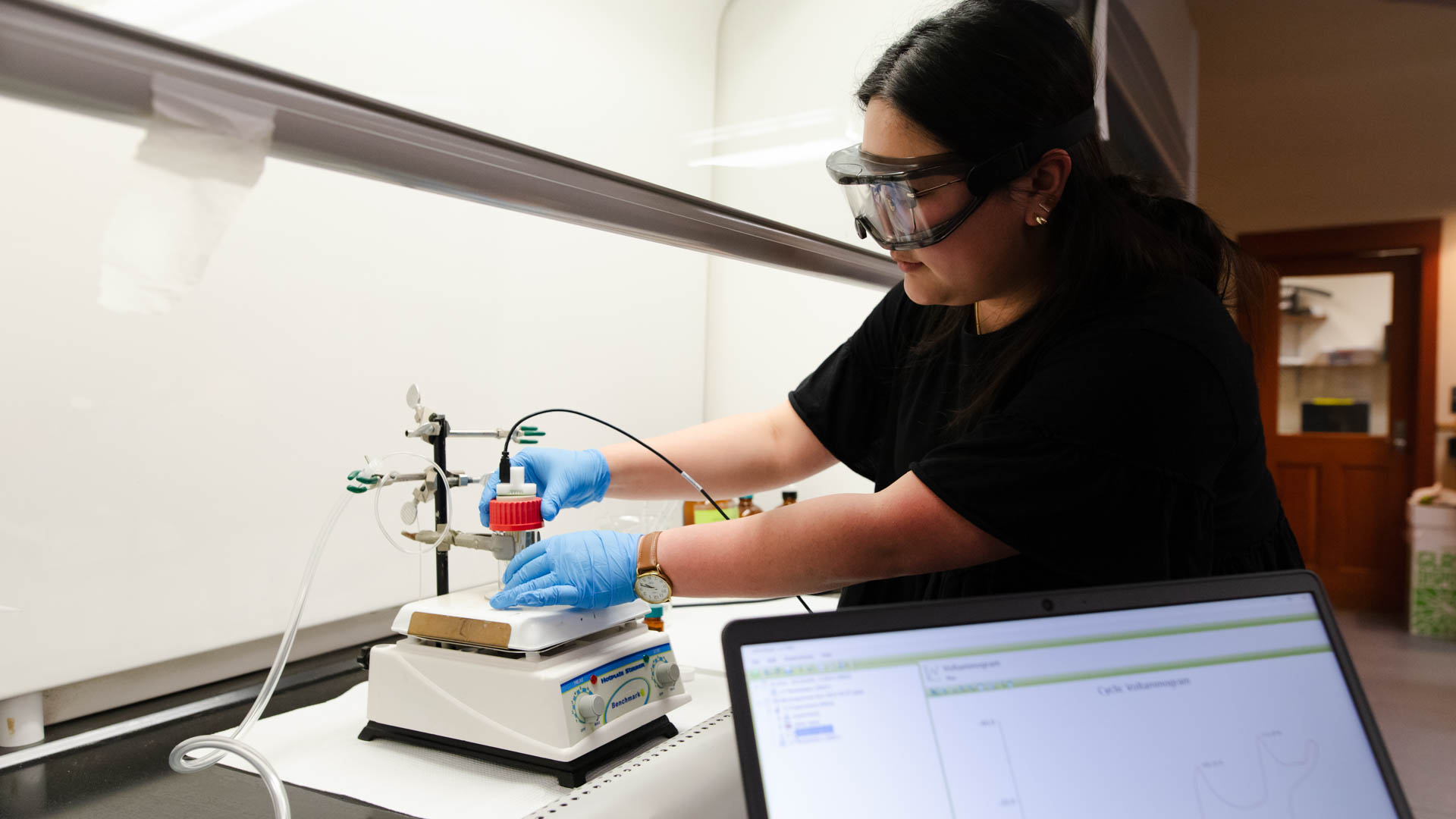 Chemistry student operating instrument