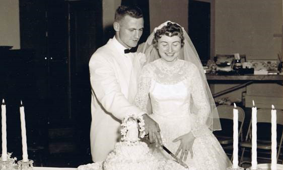 couple cutting wedding cake 