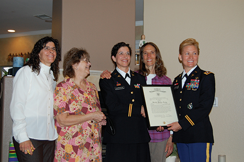 women posing together with a certificate
