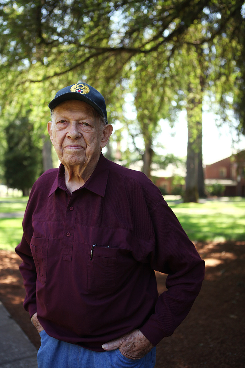 veteran standing by trees