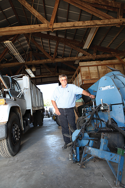 farmer standing in front of farming equipment