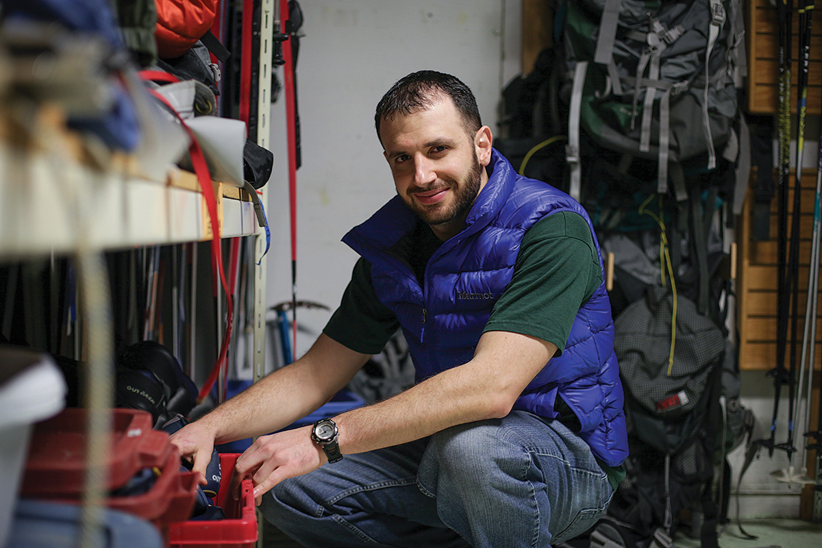 man posing next to equipment