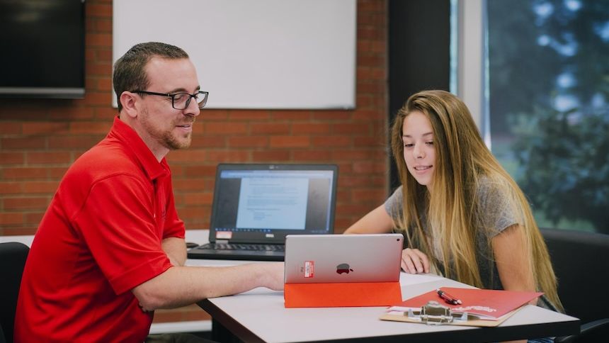 academic advisor and student working on a computer