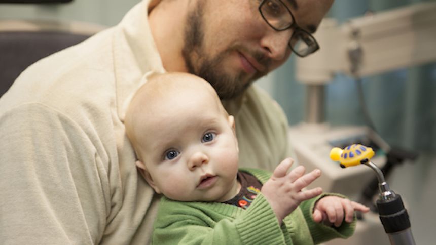 father holds his baby