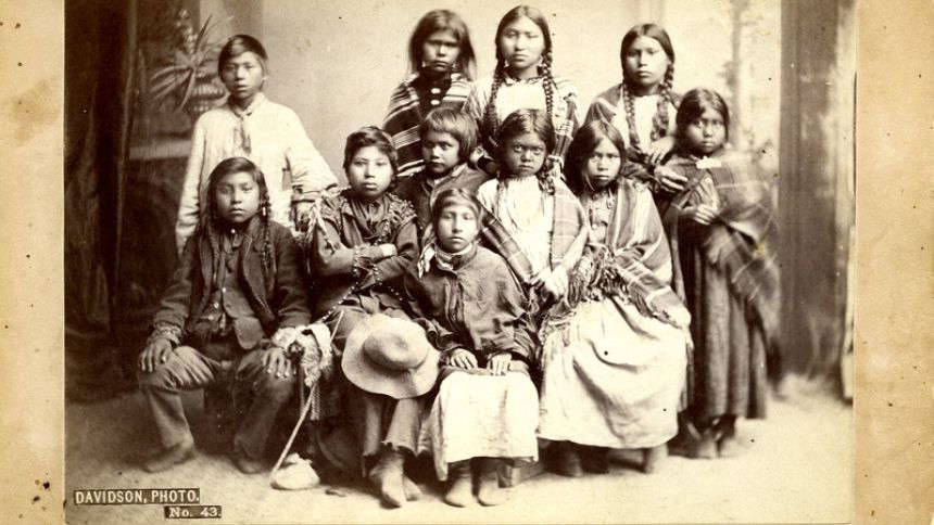 A group portrait of the second group of Spokane students taken to the Forest Grove Indian School from the band of Chief Lot. This photograph was taken at the I.G. Davidson Photography Studio in Portland, Oregon on July 8, 1881. 