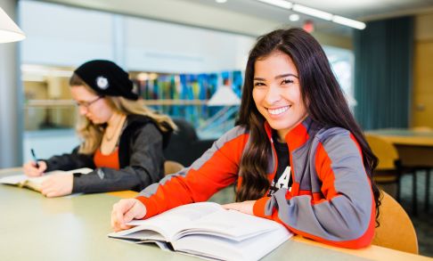 Two Pacific students study at the library on the Forest Grove campus.