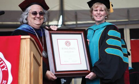 President Lesley Hallick, left, presents Dori Carlson OD '89 with the 2013 Massih Prize.