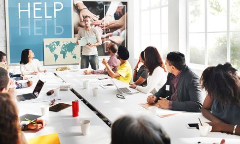 Stock photo of people around a large table in an office