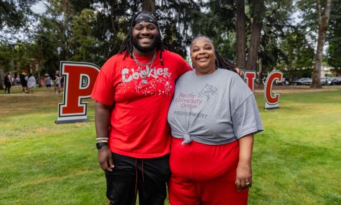 A parent poses with their adult child during move-in day at Pacific's Forest Grove campus.
