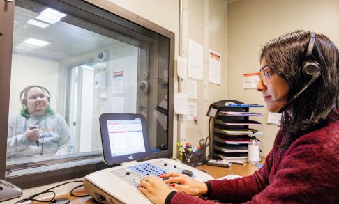A Pacific graduate student performs a hearing exam at Hillsboro Medical Center.