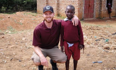 Corby pictured with a child on his mission trip.