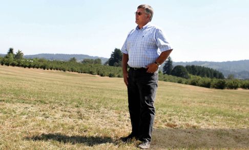 Mike Wilhoit, Pacific University Class of 1977, stands in a field