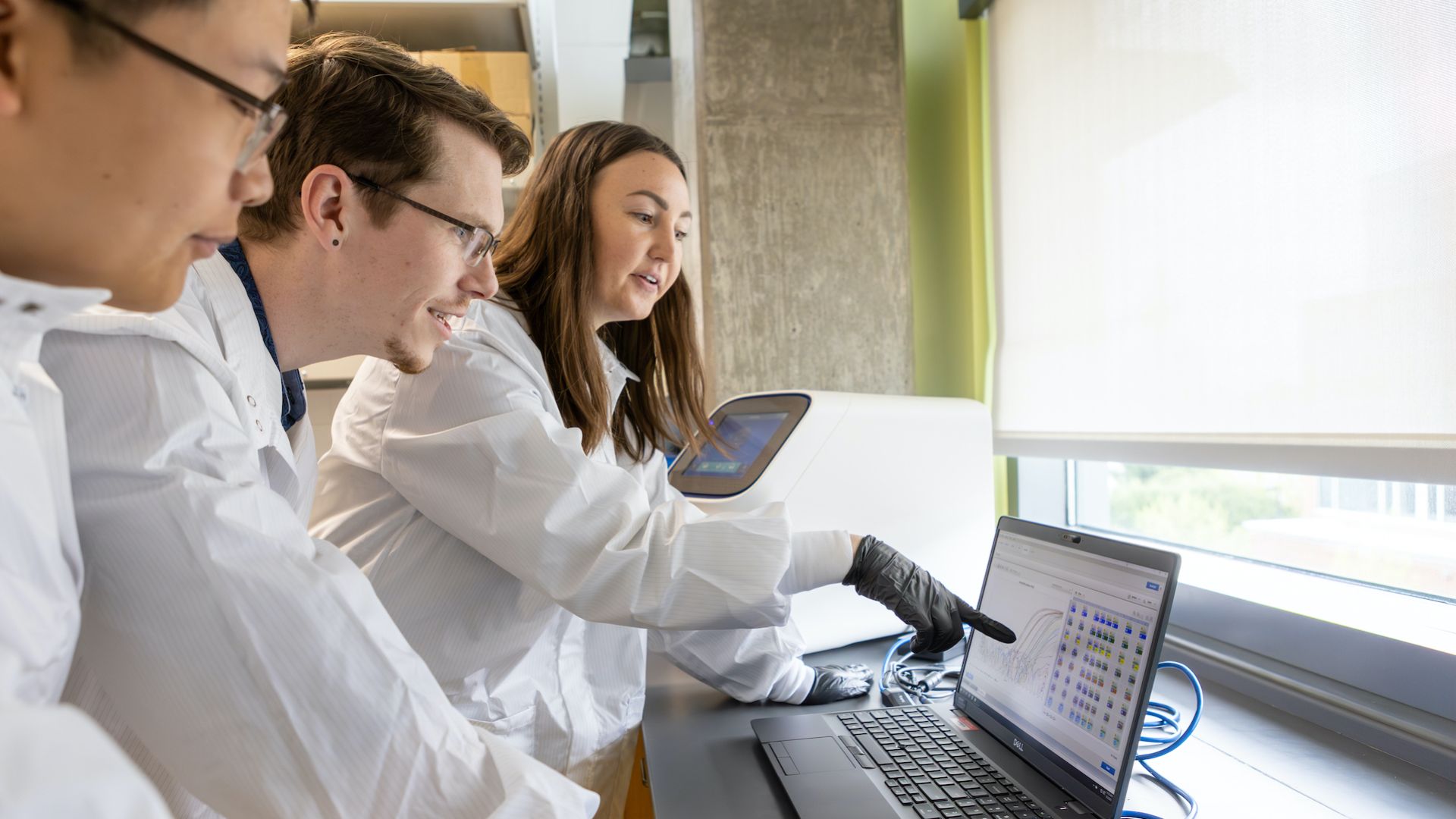 Pharmacy students looking at computer