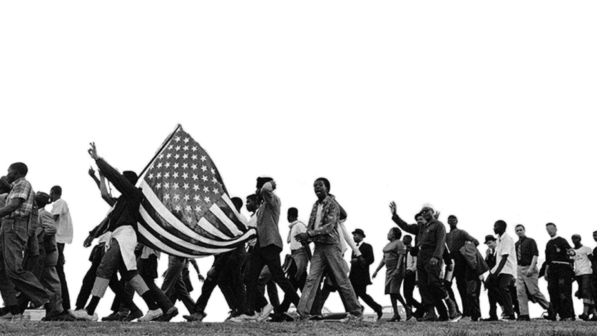 Historic photo of freedom marchers carrying American flag