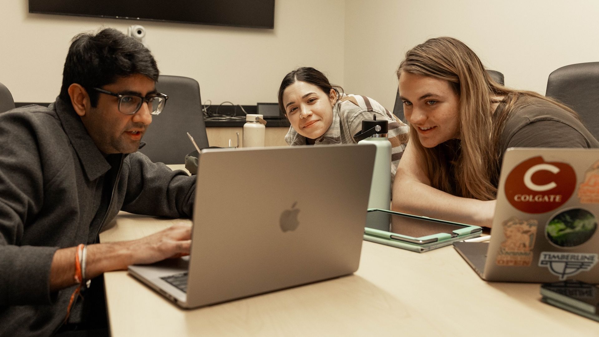 professor and student looking at laptop together